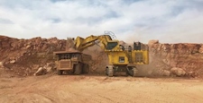 Komatsu Excavator dumping rocks in Dump Truck